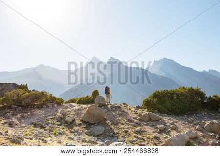 Wanderlust time. Man hiking in beautiful Fann mountains in Pamir, Tajikistan. Central Asia.
