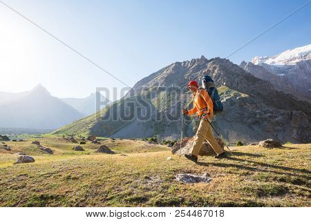 Wanderlust time. Man hiking in beautiful Fann mountains in Pamir, Tajikistan. Central Asia.
