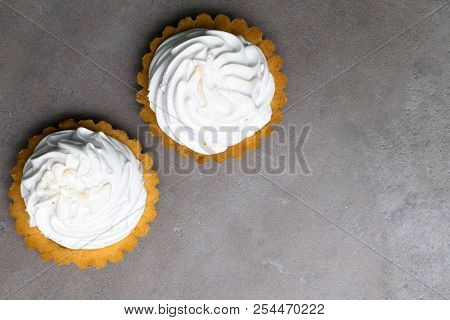 Delicious Merengue Dessert. Lemon Tartlet Tart With With Meringue On Grey Stone Concrete Table Backg