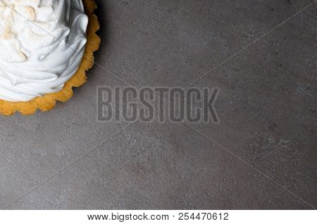 Delicious Merengue Dessert. Lemon Tartlet Tart With With Meringue On Grey Stone Concrete Table Backg