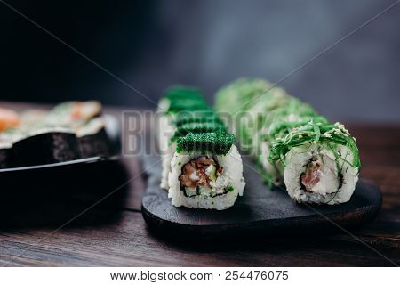 Traditional Japanese Food, Asian Cuisine Concept. Appetizing Beautiful Sushi Rolls On Dark Plate, Cl