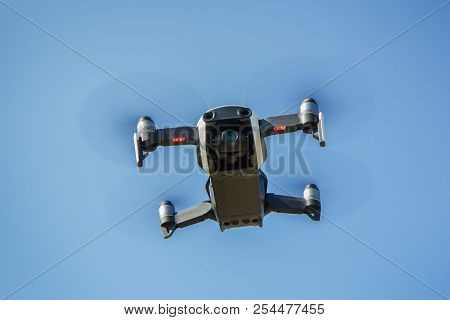 Drone With Propellers Flies In Sky And Photographs