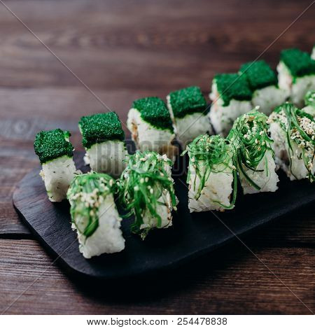 Healthy Japanese Food, Traditional Seafood. Set Of Sushi Rolls With Chuka Seaweed And Green Tobiko C