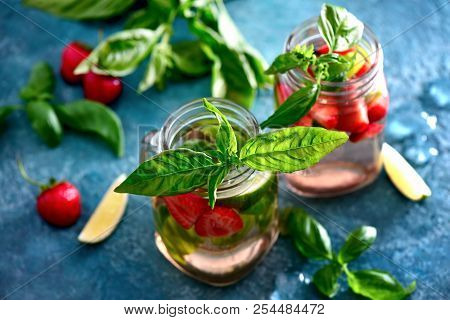 Strawberry And Basil Limeade In Two Glass Jars, View From Above