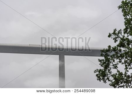 Close-up With The Kocher Viaduct Overrun By Mist And Clouds, That Supports A Highway, While A Truck 