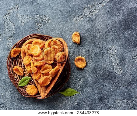 Dried Apricots On Gray Concrete Background With Copy Space. Top View.