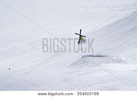 Skier Jumping In Snow Park At Ski Resort On Sun Winter Day