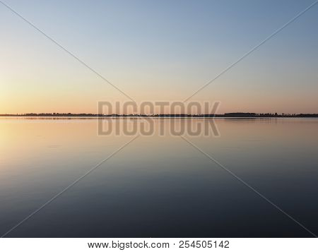 Symmetrical Sun Set Over Artificial European Goczalkowice Reservoir And Coastline Near Pszczyna City