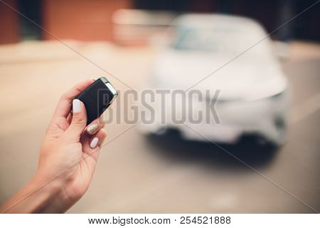 In Selective Focus Of Hand Presses On Remote Control Car Alarm Systems.cross Processing And Split To