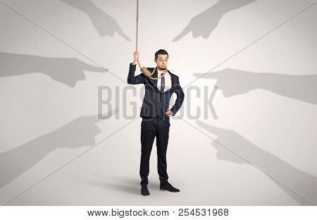 Young businessman trying to suicide with pointing hands concept