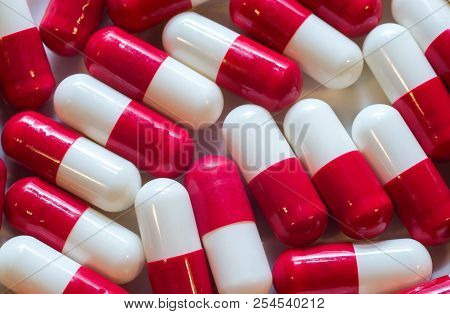 Macro Photo Shot Close-up Of Capsule Medicine White Red Color