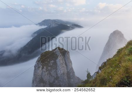 Beautiful Landscape With Stones, Forest And Fog. Sunrise In Romanian National Park Hasmas.