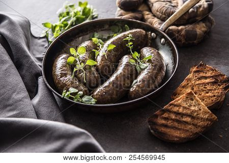 Roasted Sausages In Pan With Bread And Herbs.