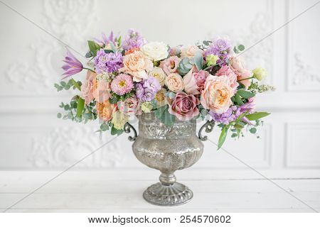 Gorgeous Bouquet Of Different Flowers. Floral Arrangement In Vintage Metal Vase. Table Setting. Lila