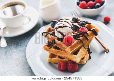 Belgian Waffles With Berries, Ice Cream And Chocolate Sauce. Closeup View, Selective Focus