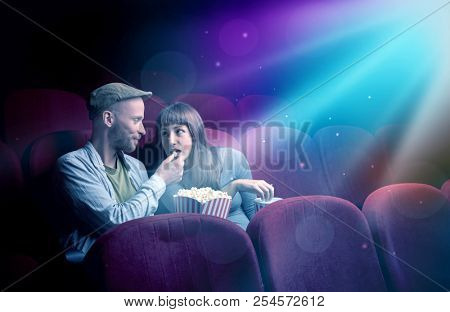 Teenager couple cuddling and watching the climax part of the movie