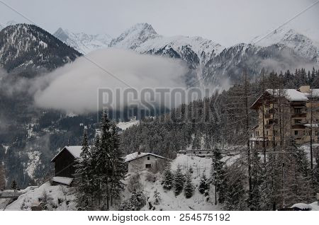 A View Of Shalets And Mountains After Heavy Snow From The Centre Of A Ski Resport In The Tirol, Aust