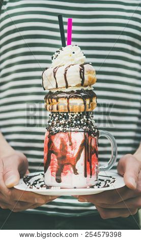 Man Holding Cold Strawberry Donut Freakshake In Mason Jar