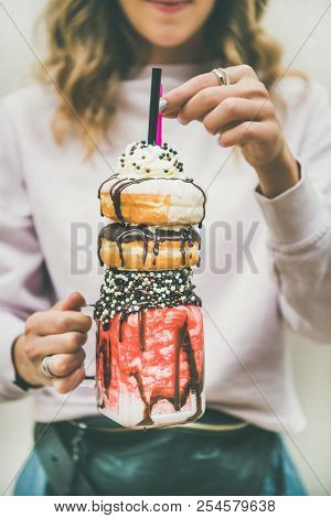 Girl Holding Cold Strawberry Donut Freakshake In Jar In Hands