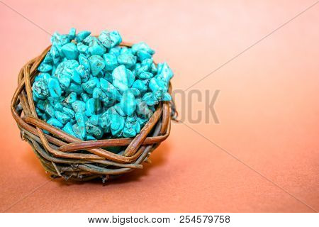 Pile Stones Of Raw Turquoise In Small Wooden Nest On A Brown Background. Blue And Green Color Stones