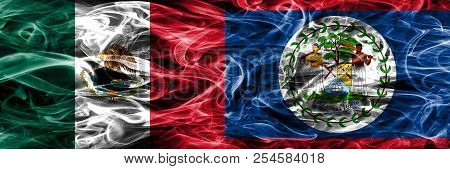 Mexico Vs Belize Smoke Flags Placed Side By Side. Mexican And Belize Flag Together