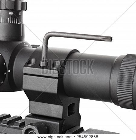 Hex Key Turning A Rifle Scope Bolt On Its Base And Rings