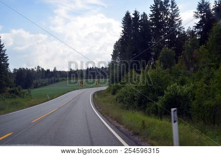 A typical Norwegian road in the countryside. June 16. 2018. Ostfold Region, Norway
