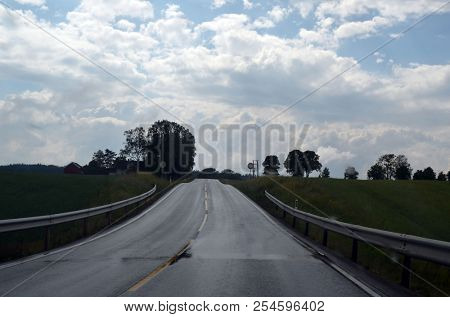 A typical Norwegian road in the countryside. June 16. 2018. Ostfold Region, Norway