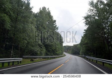 A typical Norwegian road in the countryside. June 16. 2018. Ostfold Region, Norway