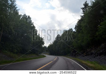 A typical Norwegian road in the countryside. June 16. 2018. Ostfold Region, Norway