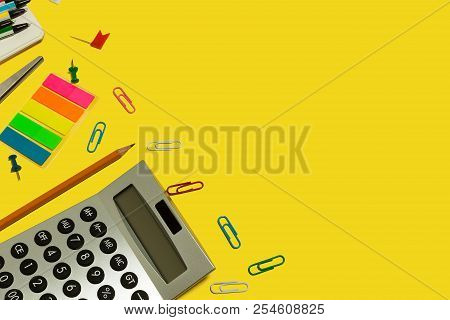 Multiple School And Office Suplies And Gadgets Lying Diagonally On A Yellow Background. Free Copyspa