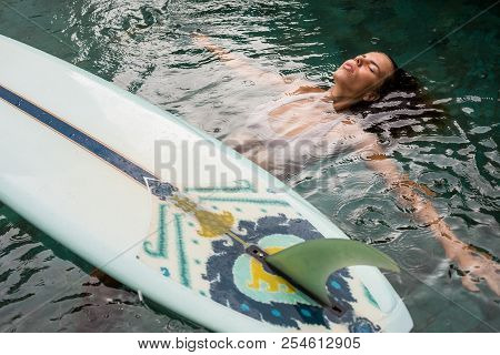 Beautiful Young Female In Sexy Bikini Relax In Pool With Her Longboard Single Fin Surfing Board Unde