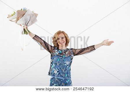 Portrait Of A Woman With A Bouquet Of Flowers In Her Hands