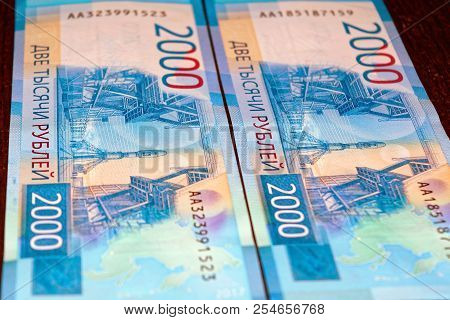 Russian Two Thousandth Notes Close-up Against The Background Of A Dark Wooden Table
