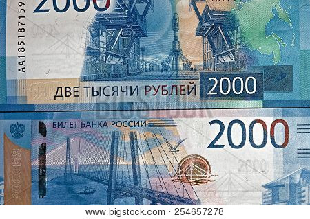 Russian Two Thousandth Notes Close-up Against The Background Of A Dark Wooden Table