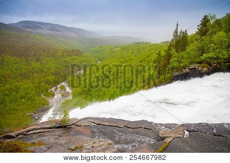 View Of Green Mountain From Valnesforsen Waterfall In Norway