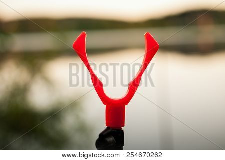 Slingshot For Installing Fishing Rods While Fishing On The Lake Background