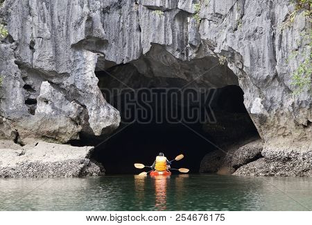 Cayakers Entering A Sea Cave In Ha Long Bay