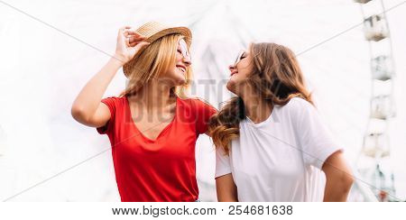 Happy Brightful Positive Moments Of Two Stylish Girls Hugging On Street In City. Closeup Portrait Fu