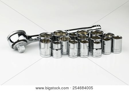 A Shiny, Silver, Chrome Socket Wrench Set With Both Sae Fractional Sockets And Metric Sockets In Mil