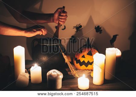 Witch Hand Boiling Potion For Spell, With Jack O Lantern Pumpkin With Candles, Broom And Bats, Ghost