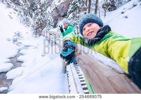 Boy Take A Selfie Picture With His Father In Snow Mountain Canyo