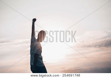 Jumping Man. Young Crazy Man Is Jumping On Rocky Summit Above Landscape. Silhouette Of Jumping Man A