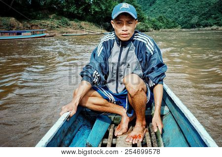 Nong Khiaw / Laos - Jul 06 2011: Lao Fisherman Istalom At Work At One Of The Small River Stream Lead
