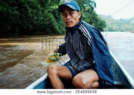 Nong Khiaw / Laos - Jul 06 2011: Lao Fisherman Istalom At Work At One Of The Small River Stream Lead