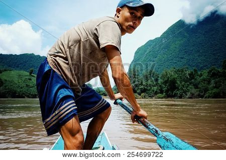 Nong Khiaw / Laos - Jul 06 2011: Lao Fisherman Istalom At Work At One Of The Small River Stream Lead