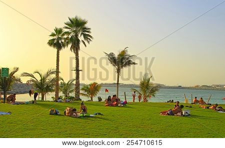 La Mer In Dubai, Uae - May 06, 2018: People Rest On The Beach At Sunset. It Is A New Beachfront Dist