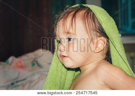 A Child With Wet Hair Wrapped In A Green Towel. Healthy Lifestyle