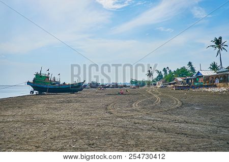 The Wet Dirt On Kangy River Bank At The Low Tide, Villagers Collect The Small Crabs And Shrimp Among