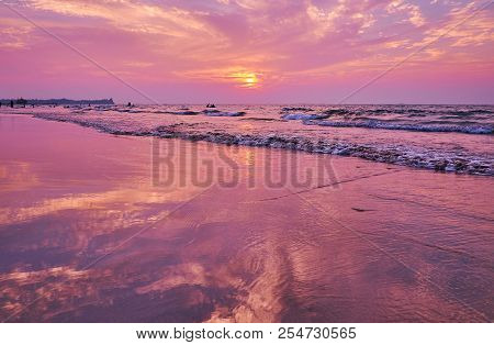The Evening Walk Along The Beach In Chaung Tha Resort With A View On Sunset Sky And Its Bright Refle